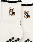 Close-up of The Tri Color Corgi Grip Sock detailing the embroidered tri-color corgi design and paw-shaped non-slip grip soles