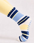 Woman holding a plank in blueberry lemon striped grip socks, close-up of the non-slip sole