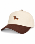 Side angle of The Doxie Brown Hat showing the embroidered dachshund and curved brown brim