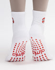 White socks with red patterns and text worn with beige tights on a white background