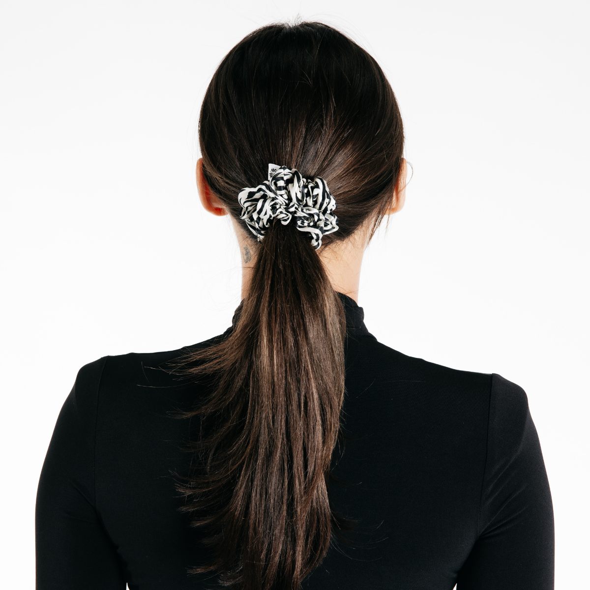 Zebra silk scrunchie shown in black and white zebra print, a soft hair tie for Pilates and everyday wear