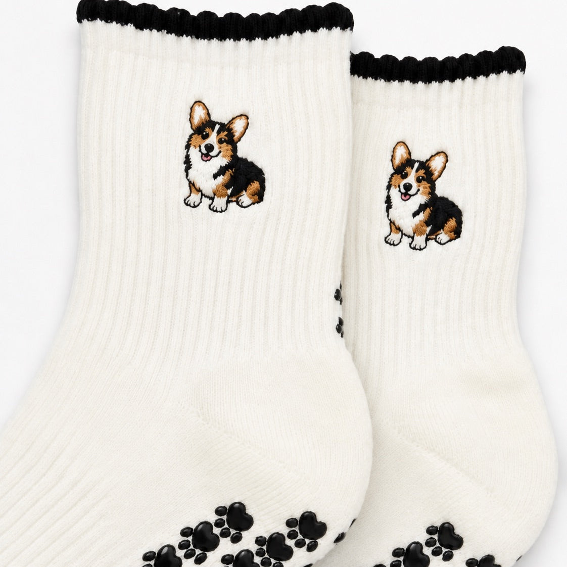 Close-up of The Tri Color Corgi Grip Sock detailing the embroidered tri-color corgi design and paw-shaped non-slip grip soles