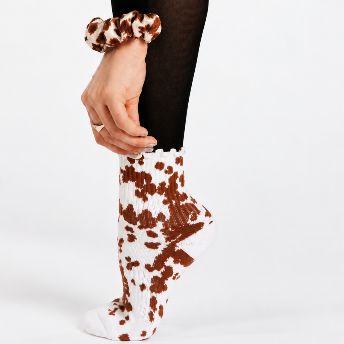 Cowhide Pilates grip socks shown with the matching cowhide mulberry silk scrunchie