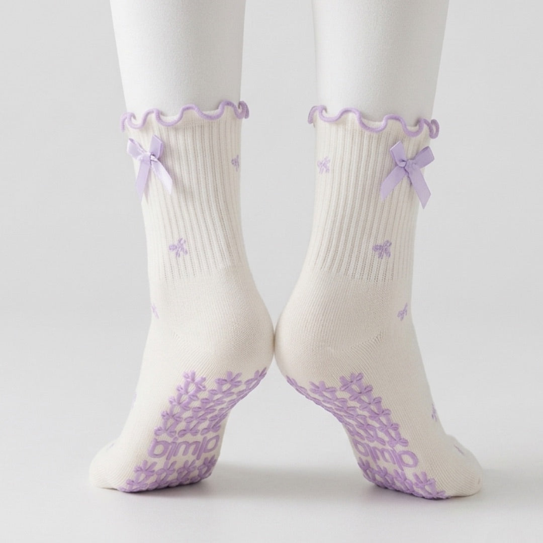 Bow print crew grip socks with lavender ribbon ties, back view with grip soles showing