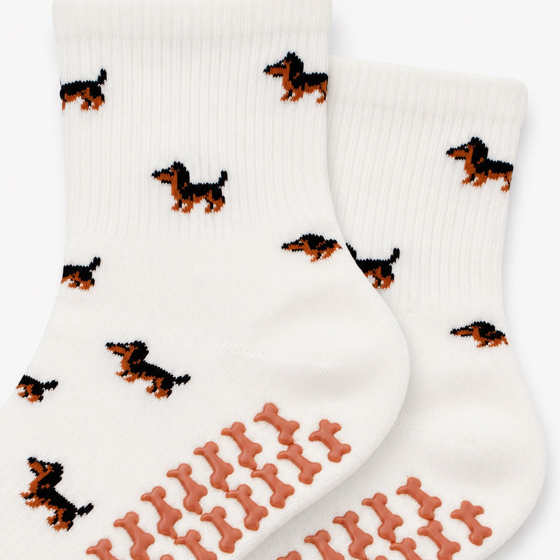 Close-up of The Dachshund Grip Sock detailing the all-over dachshund print and dachshund-shaped non-slip grip soles