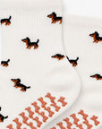 Close-up of The Dachshund Grip Sock detailing the all-over dachshund print and dachshund-shaped non-slip grip soles
