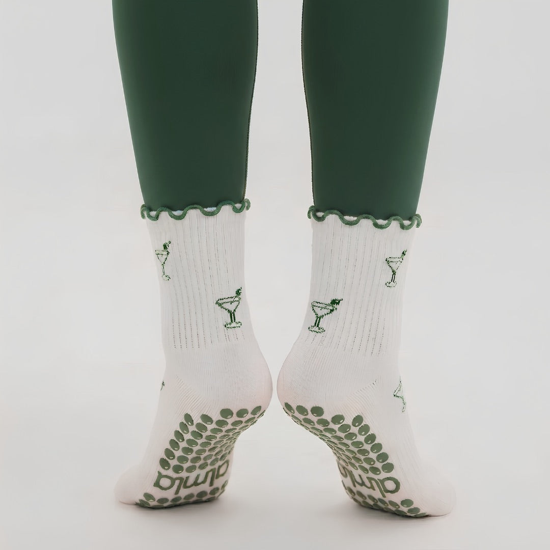 Martini print crew grip socks worn with green leggings, back view with grip soles showing