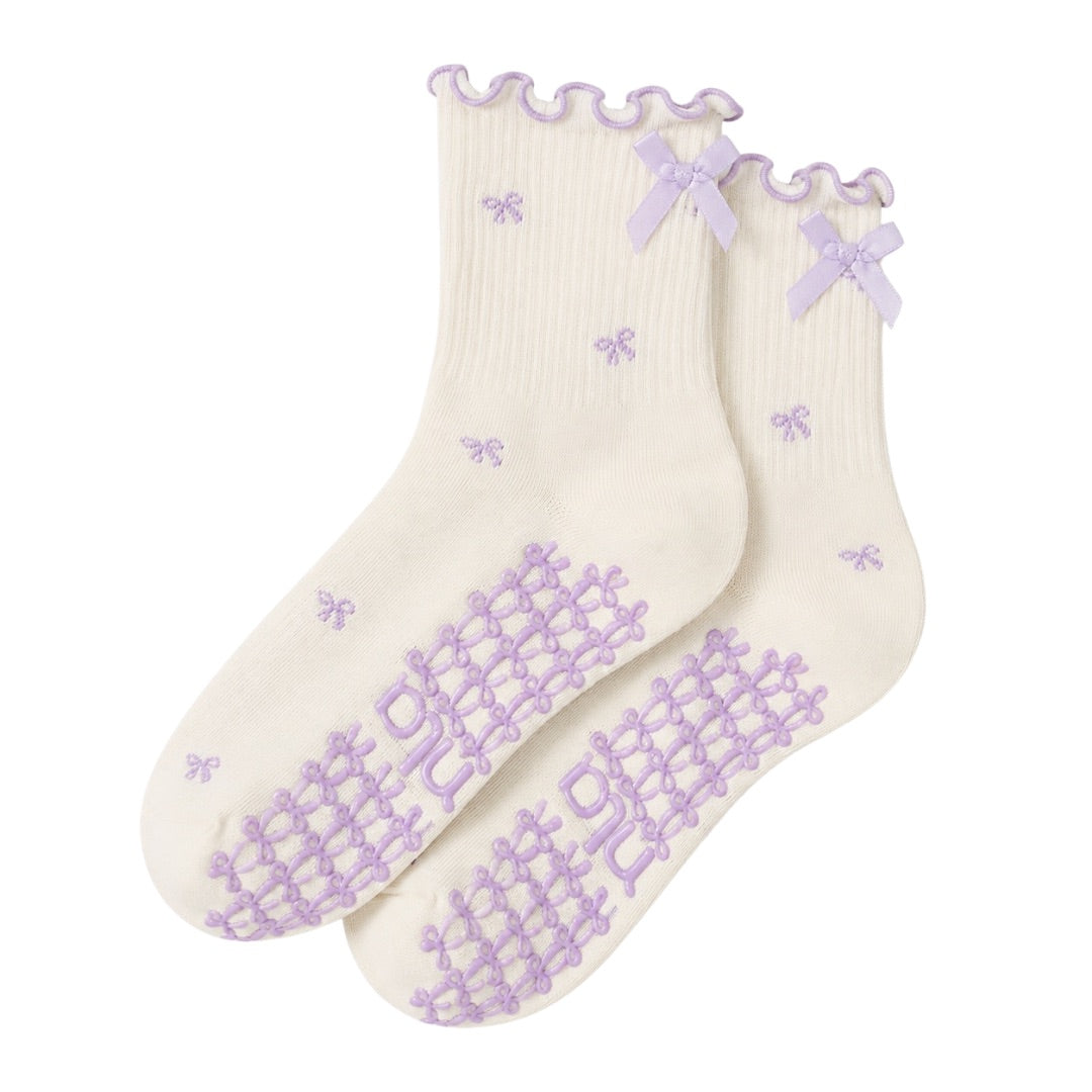 Lavender bow grip socks in cream with purple bow print, ribbon cuff and non-slip sole