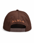 Back view of The Goldendoodle Brown Hat showing tan ALMLA embroidery arched above the adjustable snapback