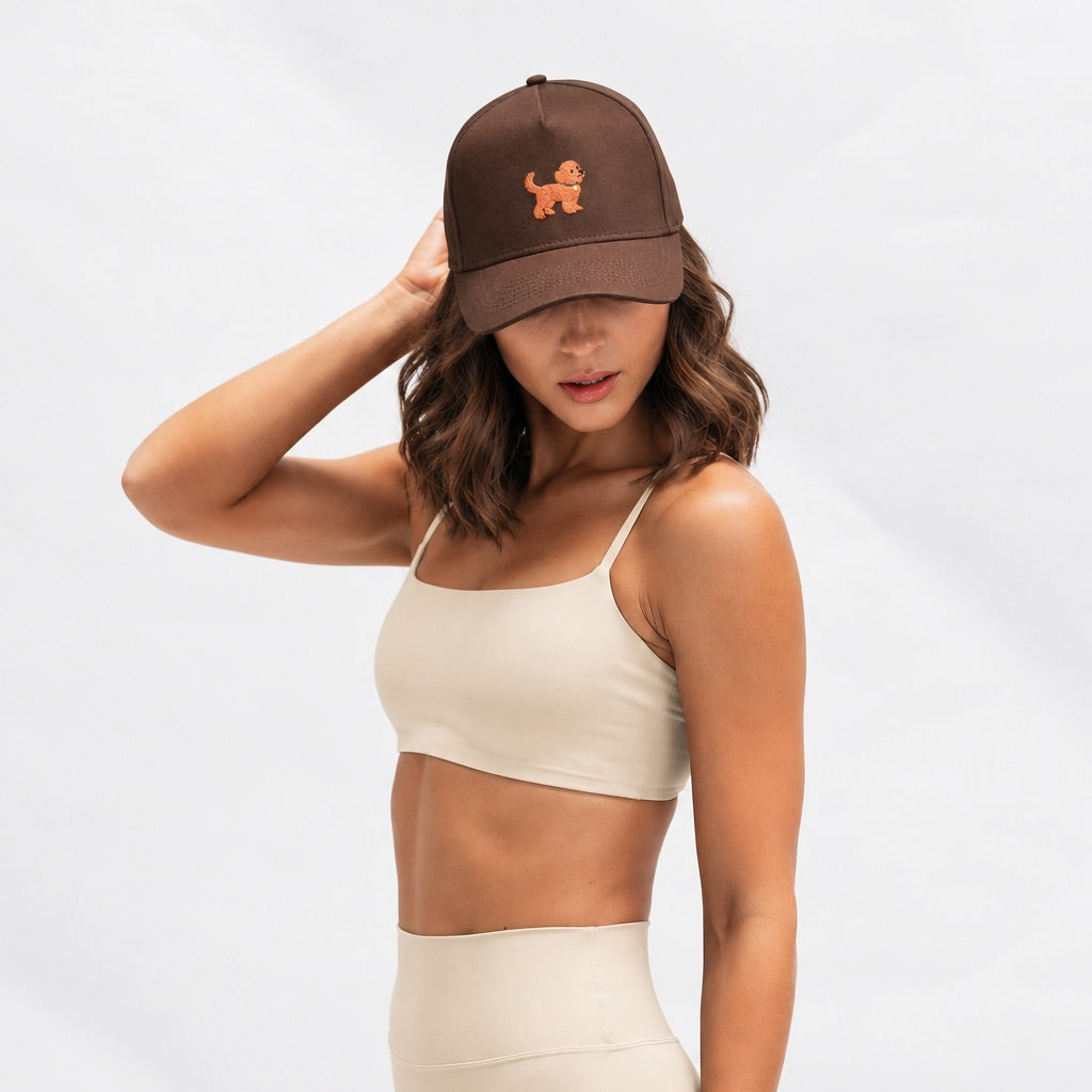Woman in a cream matching set wearing The Goldendoodle Brown Hat, angled view