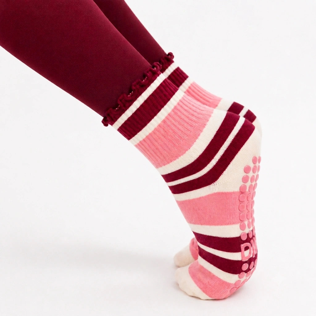 Pointed toe in burgundy leggings wearing raspberry cream grip socks with pink sole grips